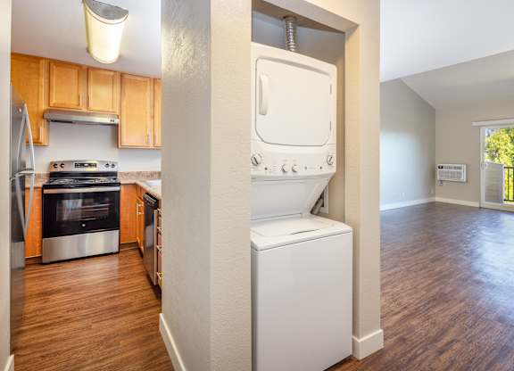 A modern kitchen with wooden cabinets and a white dishwasher.