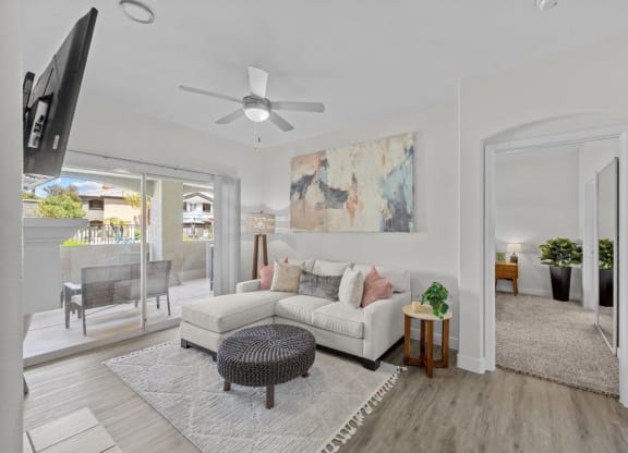 a living room with a couch and a ceiling fan