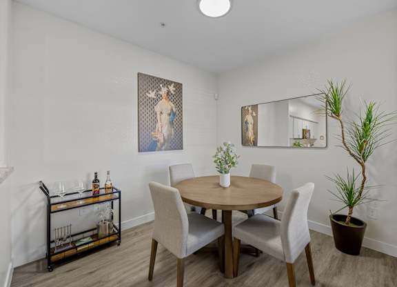 A dining room with a round table and chairs.