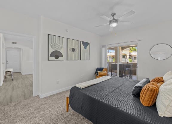 a bedroom with a bed and a ceiling fan