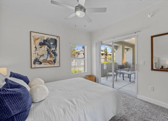 a bedroom with a bed and a ceiling fan