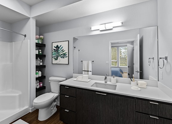 A bathroom with a white tub, sink, and toilet.