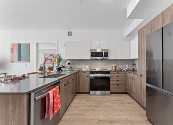 A modern kitchen with wooden cabinets and stainless steel appliances.