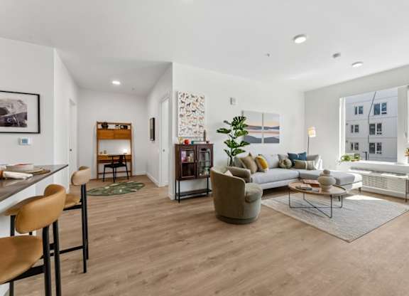 A modern living room with a wooden floor and furniture.