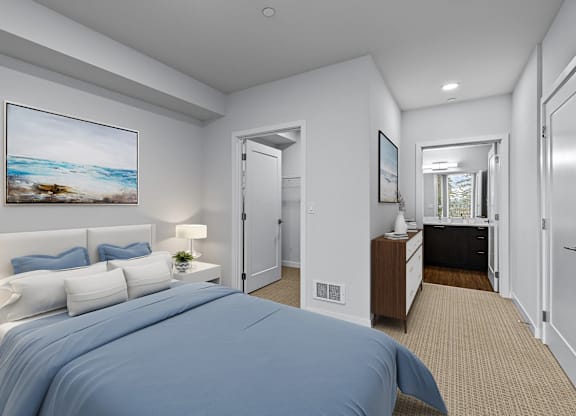 A bedroom with a large bed and a painting on the wall.