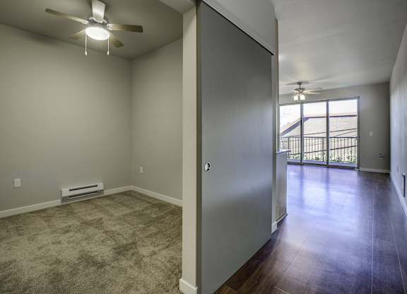 A room with a ceiling fan and a window.