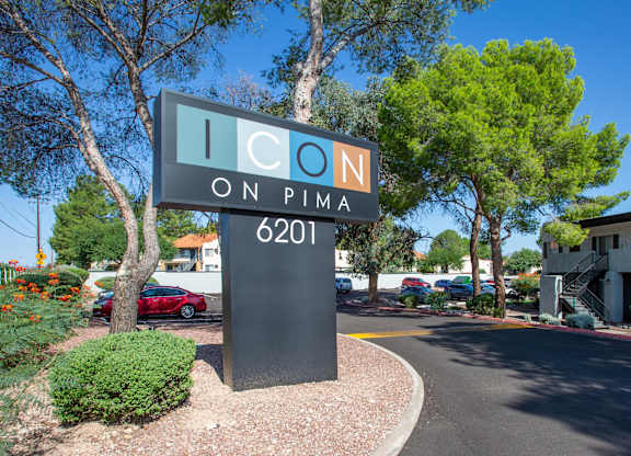 A sign for Icon on Pima 6201 is in front of a building.