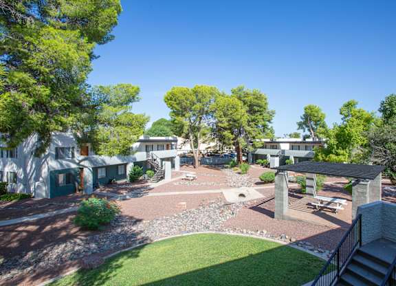 A backyard with a patio and a small garden.