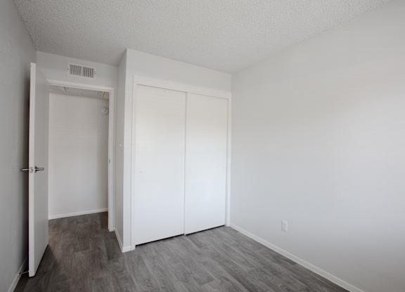 A room with a white door and a white closet.