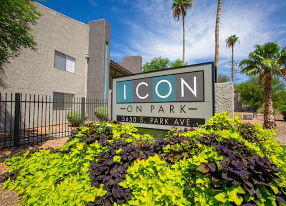 A sign for Icon on Park stands in front of a building.