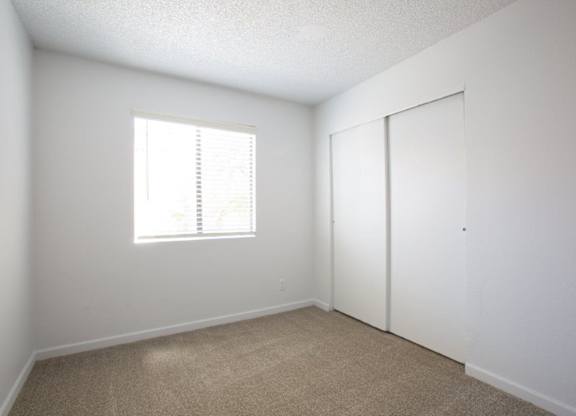 A room with a window and a door.