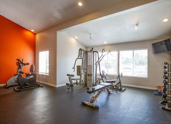 A spacious home gym with a variety of exercise equipment.