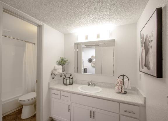 A bathroom with a white toilet and a white sink.