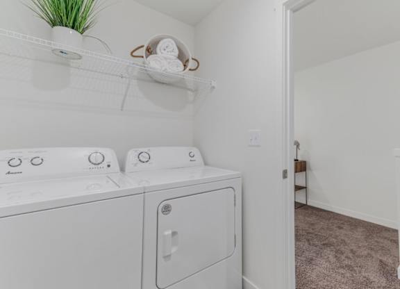 A white washing machine and dryer in a laundry room.