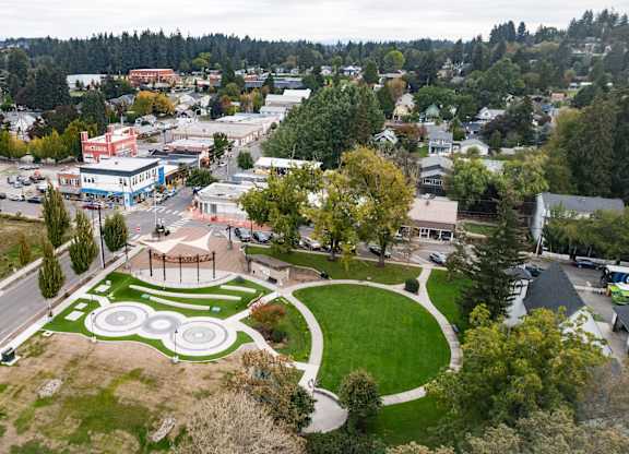 A park with a circular design in the middle of a town.