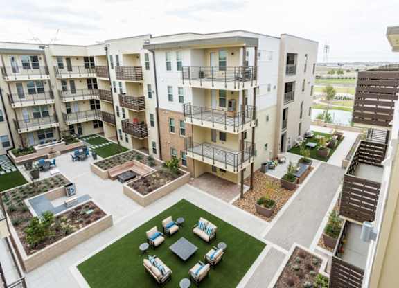 Apartment complex with a courtyard and a patio.