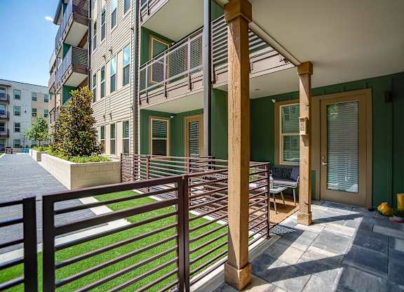 A balcony with a railing and a bench is shown.