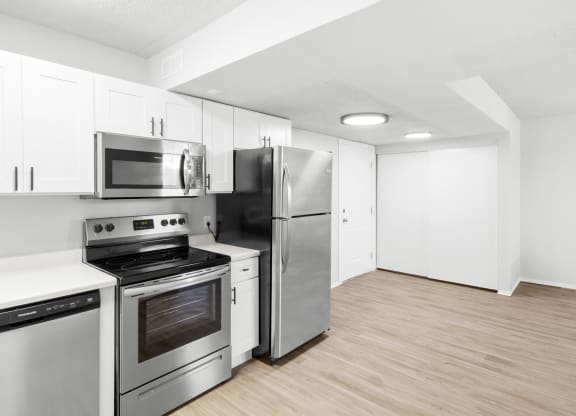 Proximity Apartment Homes Kitchen with stainless steel appliances and white cabinets