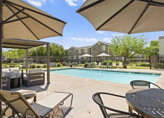 Proximity Apartment Homes Pool with lounge chairs and tables