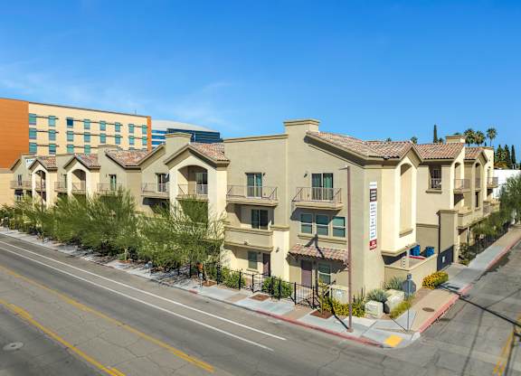 A row of townhouses with a clear blue sky above.