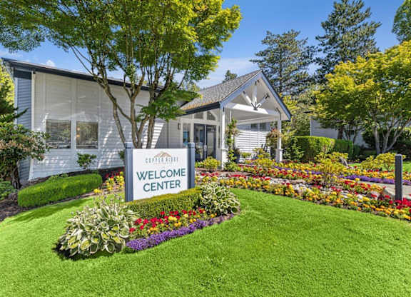 A white building with a sign that says Welcome Center.