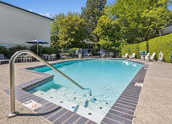 A pool with a slide and no swimming allowed sign.