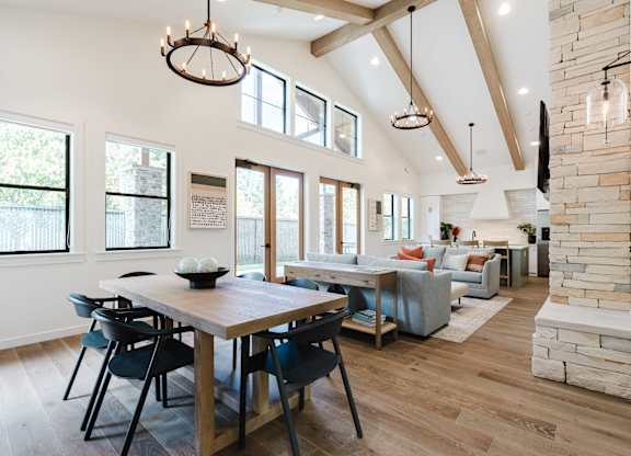 A dining room with a wooden table and chairs.