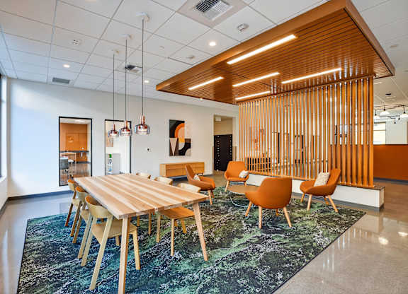 A conference room with a long table and chairs.