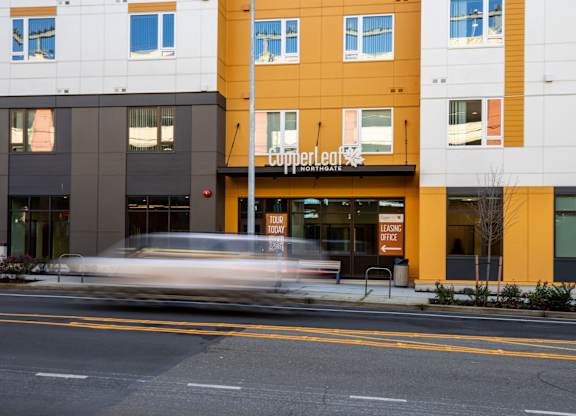 A building with a yellow and black exterior and a sign that reads "cupperleaf" is in the background.