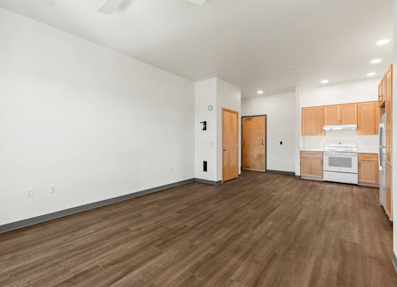 A room with wooden floors and white walls.