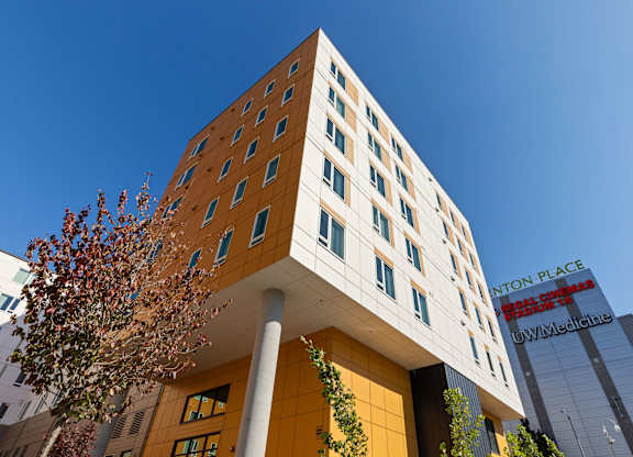 A tall building with a tree in front of it.