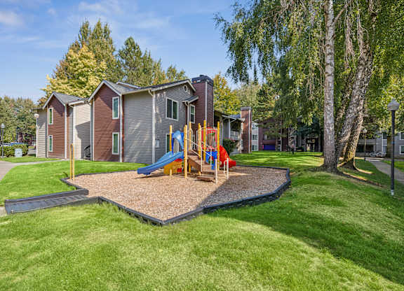 A playground area is located in front of a building.