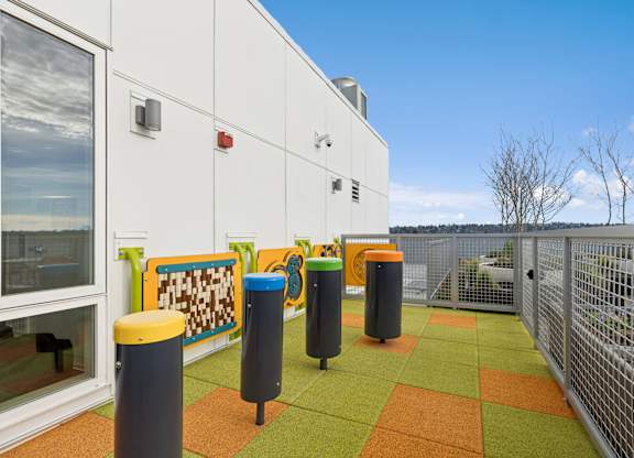 A white building with a green and orange tiled floor.
