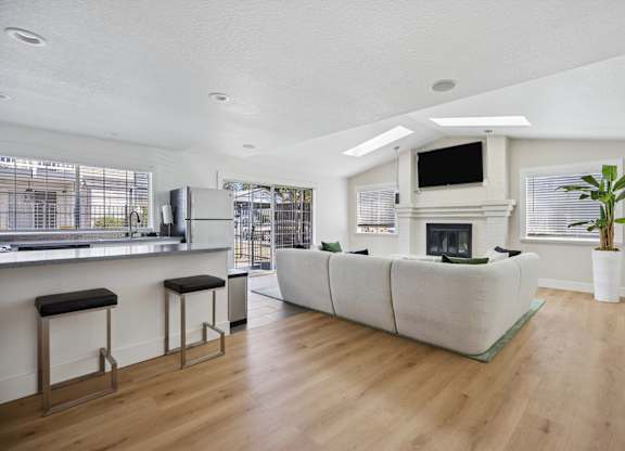 A modern living room with a fireplace and a bar area.