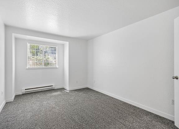 A room with a window and a door.