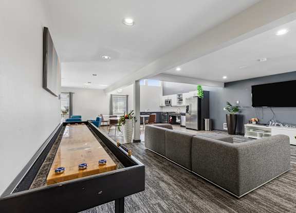 A room with a pool table and a couch.