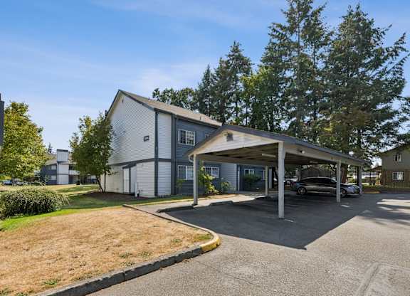 A carport is attached to a modern house.