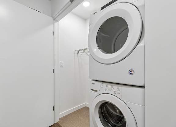 A white washing machine and dryer in a laundry room.