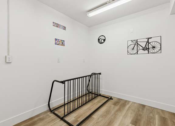 A white wall with a bicycle drawing and a clock on it.