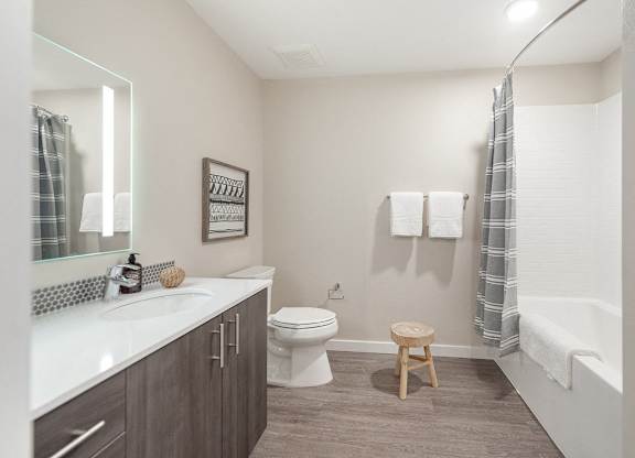 A bathroom with a toilet, sink, and a shower curtain.
