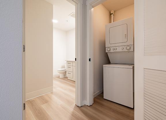 A small white laundry room with a washer and dryer.