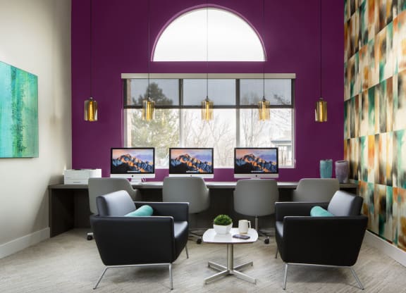 an office with purple walls and a large window