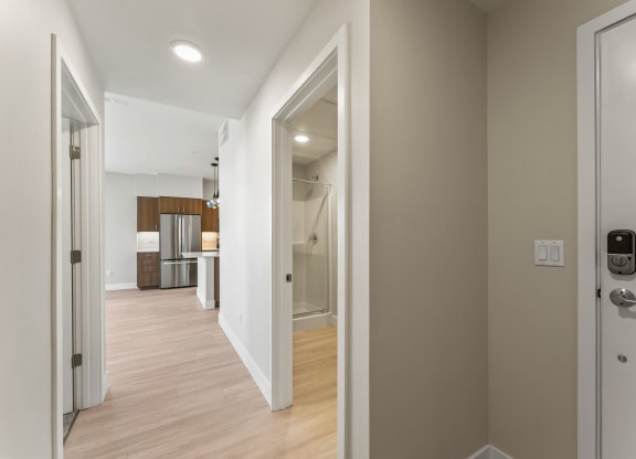 a view of the hallway from the front door of a house