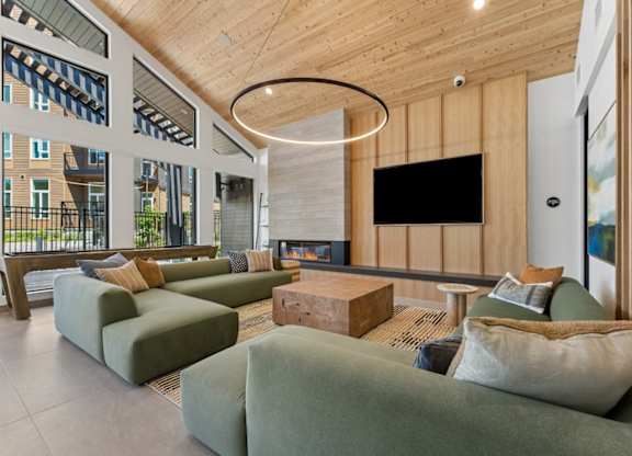 A modern living room with a fireplace and a flat screen TV.