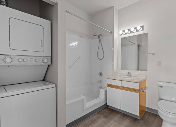 A white toilet sits next to a sink in a small bathroom.