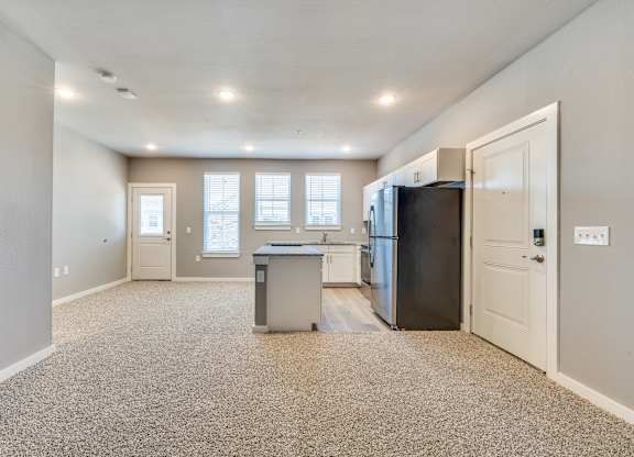 A kitchen with a black refrigerator at Four Cedars, Gunter, TX 