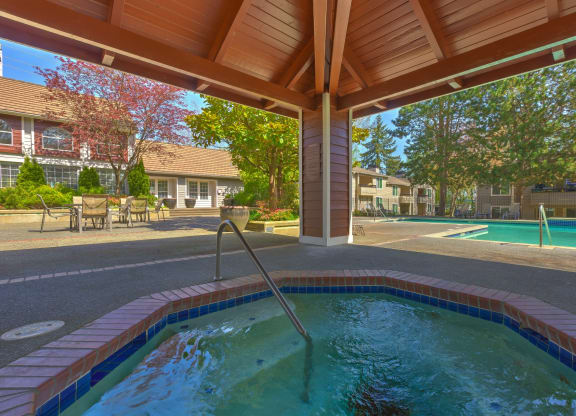 a resort style pool is under a wooden roof