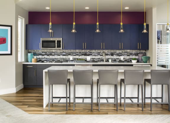 a kitchen with a large center island with a white countertop