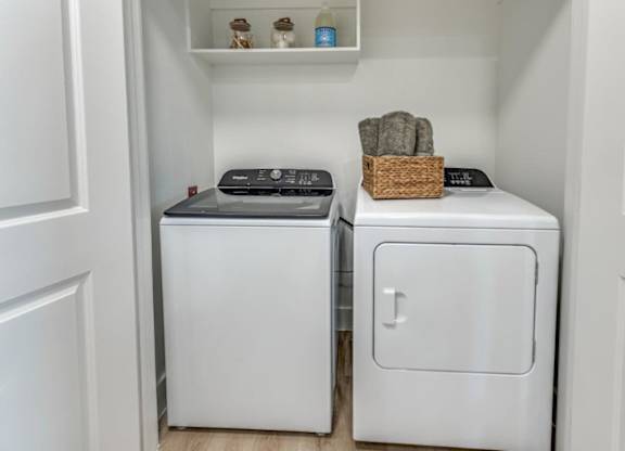 A small laundry room with a washer and dryer.