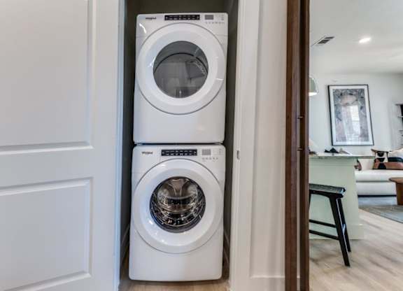 A white front loading washing machine in a modern home.
